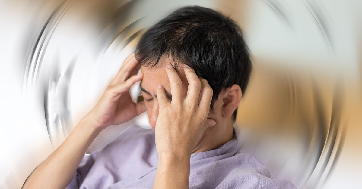 Vertigo illness concept. Man hands on his head felling headache